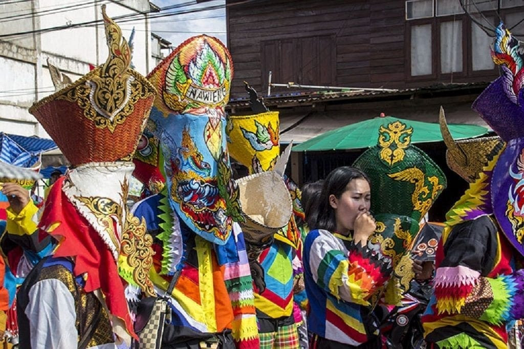 vivid processions in bizarre masks and costumes of snakes