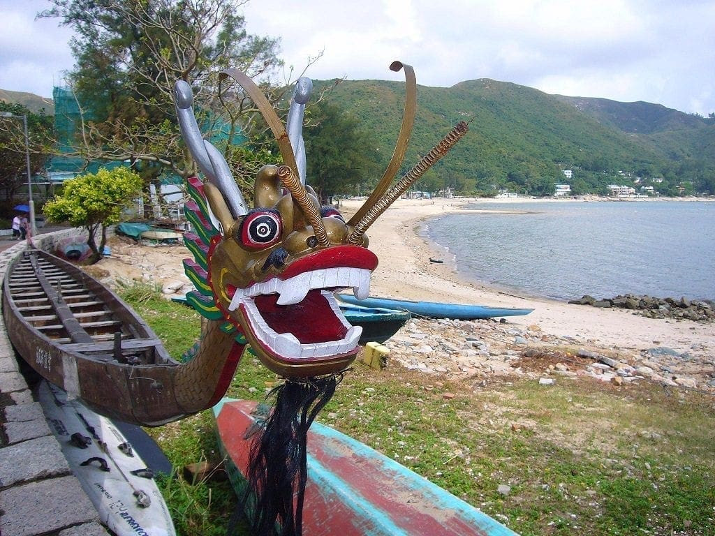 The boats are adorned with richly carved and painted dragon heads